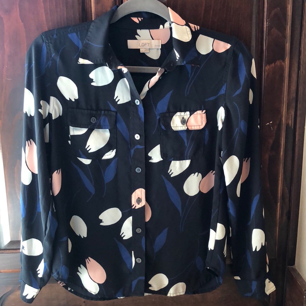 Black blouse with large white, blush, blue print.